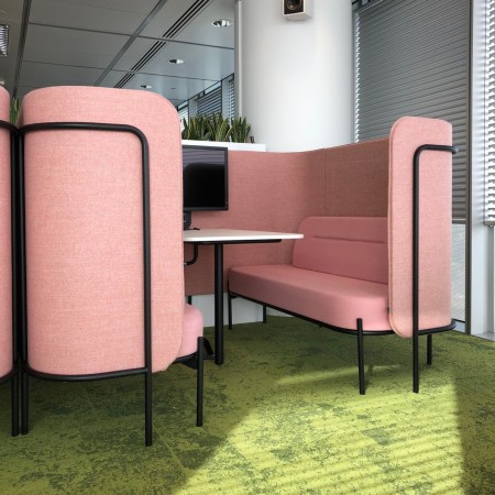 Alcôve Fora rose avec banquettes et table rectangulaire, créant un espace convivial dans un bureau moderne. - Fora