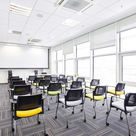 Chaises de conférence Kyos disposées en rangée dans une salle de formation moderne