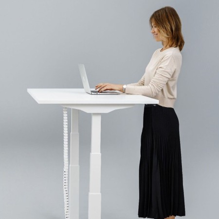 Poste de travail ergonomique avec bureau Q-ACTIVE dans des bureaux à Genève.