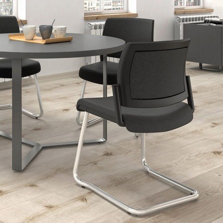 Espace détente en entreprise à Berne avec chaises AURA noires et chrome.