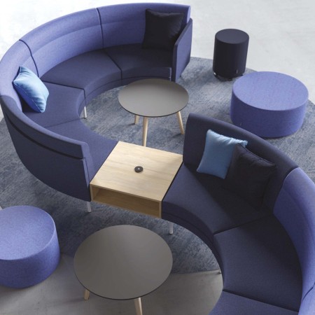 Canapé modulaire ARCIPELAGO avec modules bicolores et tablette centrale pour espace d'accueil contemporain à Montreux.